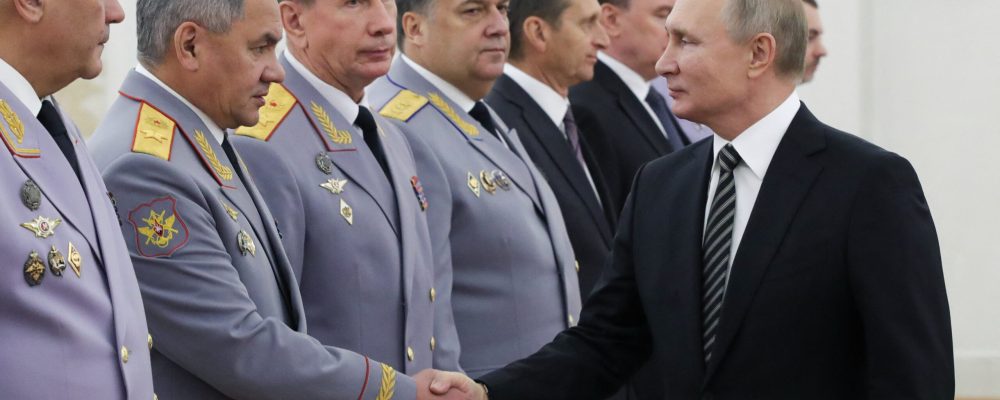 Russian President Vladimir Putin shakes hands with Defence Minister Sergei Shoigu during a meeting with newly promoted senior military officers who were awarded higher military (special) ranks at the Kremlin in Moscow on November 6, 2019. (Photo by Mikhail Klimentyev / SPUTNIK / AFP)