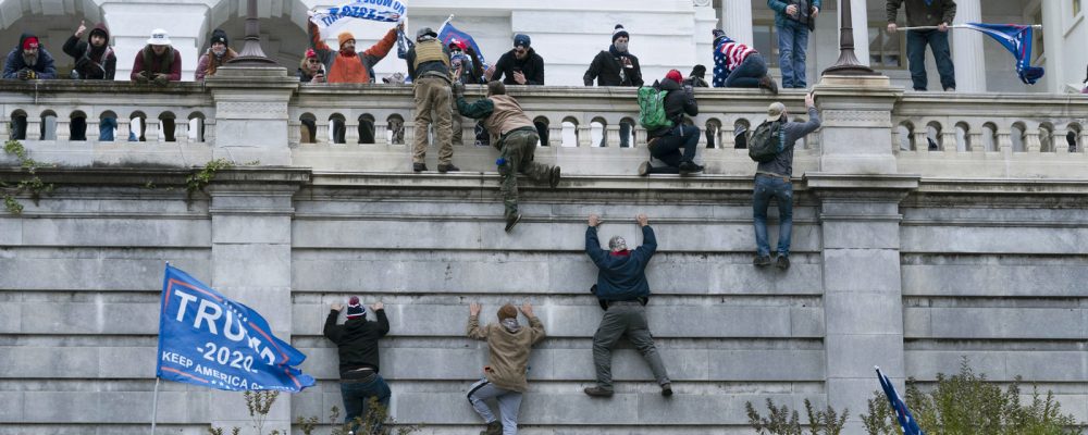 FILE - Supporters of President Donald Trump climb the west wall of the the U.S. Capitol on Jan. 6, 2021, in Washington. (AP Photo/Jose Luis Magana, File)