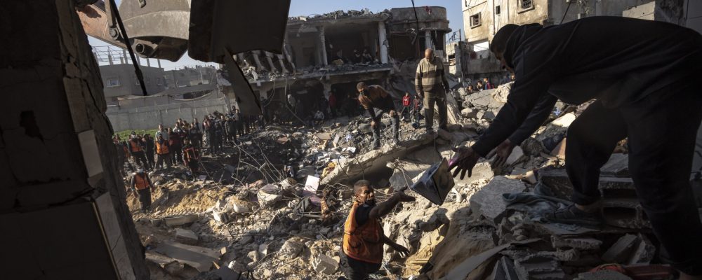 Palestinians search for bodies and survivors in the rubble of a residential building destroyed in an Israeli airstrike, in Rafah, southern Gaza Strip, Tuesday, Dec. 19, 2023. (AP Photo/Fatima Shbair)