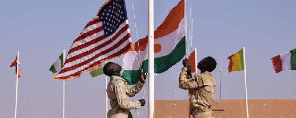 Soldiers assigned to the Forces Armees Nigeriennes raise the Nigerien and U.S. flags during an opening ceremony at the Joint Multinational Headquarters for Flintlock 2018 at Agadez, Niger, April 11, 2018. Flintlock is an annual, African-led, integrated military and law enforcement exercise that has strengthened key partner nation forces throughout North and West Africa as well as western Special Operations Forces since 2005. (U.S. Army photo by Sgt. 1st Class Mary S. Katzenberger, 3rd Special Forces Group (Airborne)/Released)