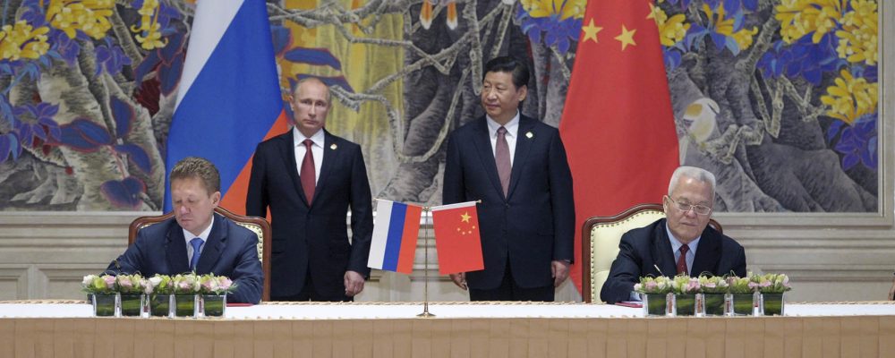 Russian President Vladimir Putin and Chinese President Xi Jinping stand during the signing of a gas deal in Shanghai, May 21, 2014. China and Russia agreed to a major 30-year natural gas deal Wednesday that would send gas from Siberia by pipeline to China, according to the China National Petroleum Corporation. (Alexei Druzhinin/RIA Novosti/Pool via The New York Times) -- FOR EDITORIAL USE ONLY. --