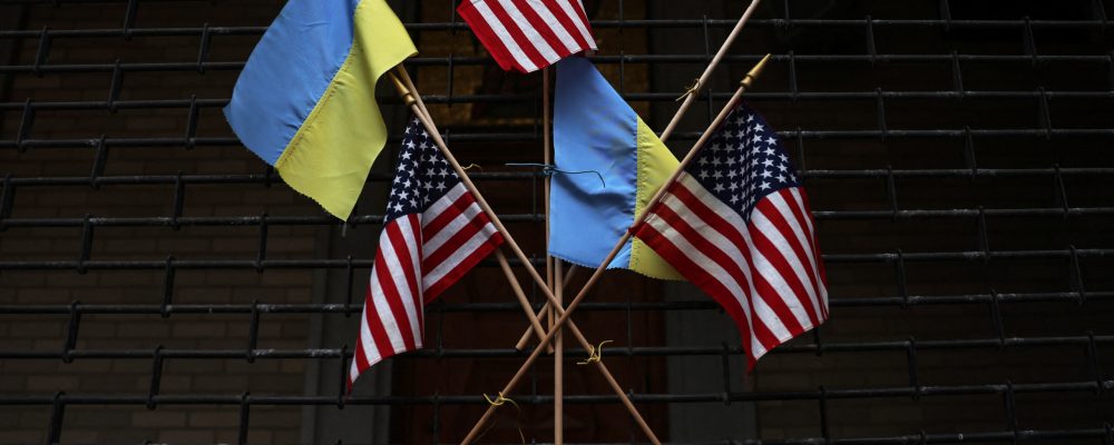 The flags of the United States and Ukraine hang on the fence of the Saint George Ukrainian Catholic Church in New York City, U.S., March 6, 2023. REUTERS/Shannon Stapleton/File Photo