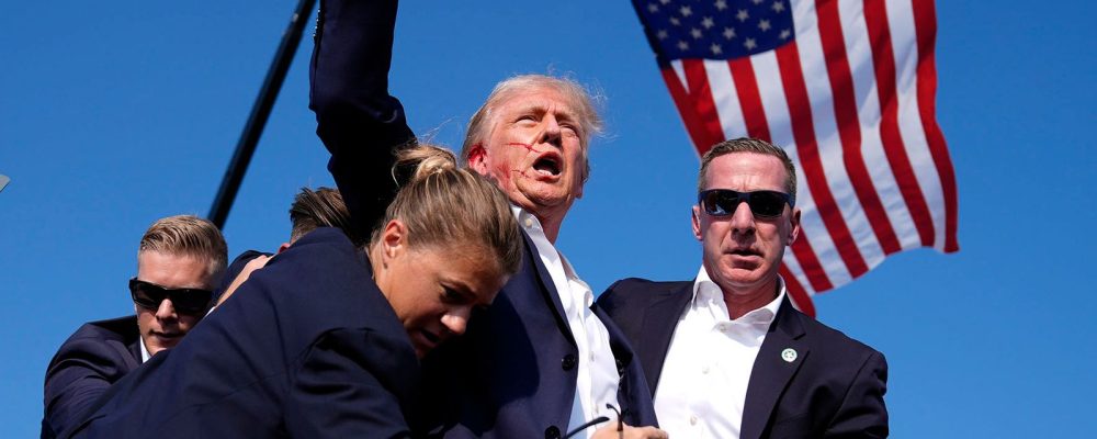 Republican presidential candidate former President Donald Trump is surrounded by U.S. Secret Service agents at a campaign rally, Saturday, July 13, 2024, in Butler, Pa. (AP Photo/Evan Vucci)