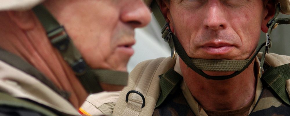 Camp New Jersey, Kuwait -- Maj. Gen. David H. Petraeus, commander, 101st Airborne Division, (Air Assault) looks on as Lt. Gen. William S. Wallace, 5th Corps commander speaks to people following a scud drill Thursday afternoon. Photo by Pfc. Joshua Hutcheson, 101st journalist.