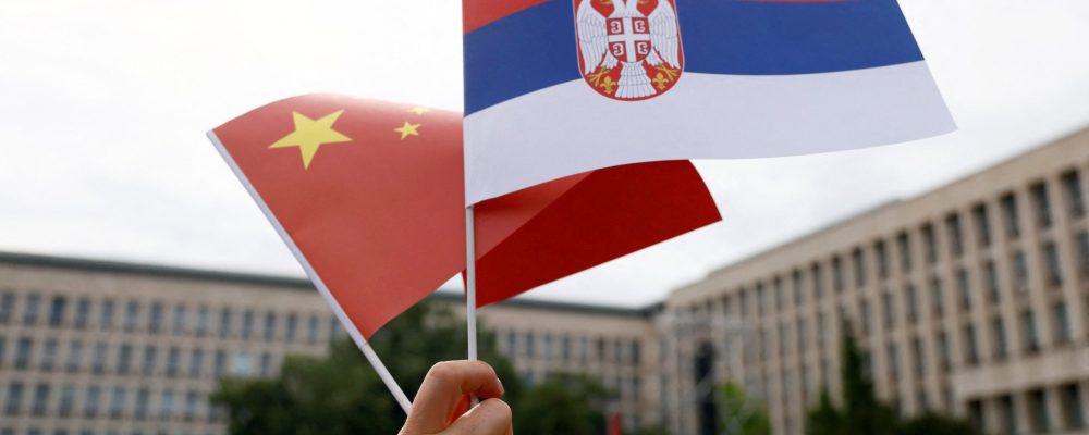 TOPSHOT - People waving Chinese and Serbian flags gather outside the Palace of Serbia during a welcome ceremony for Chinese President Xi Jinping in Belgrade, on May 8, 2024. Chinese President Xi Jinping will hold talks with his Serbian counterpart in Belgrade on May 8, 2024, as Beijing seeks to deepen its political and economic ties with friendlier countries in Europe. (Photo by STRINGER / AFP) (Photo by STRINGER/AFP via Getty Images)