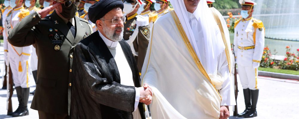 In this photo released by the official website of the office of the Iranian Presidency, Qatari Emir Sheikh Tamim bin Hamad Al Thani, right, shakes hands with President Ebrahim Raisi during an official arrival ceremony at the Saadabad Palace in Tehran, Iran, Thursday, May 12, 2022. Qatar's emir arrived in Tehran for talks with the Iranian president as efforts to save Tehran's tattered nuclear deal with world powers hit a deadlock. (Iranian Presidency Office via AP)